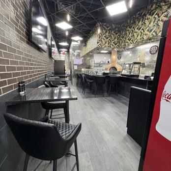 Addobbo Wood-Fired Pizza - Small eat in bar tables with very comfortable chairs plus one booth. - Pizza Near Me - Sanford, Florida