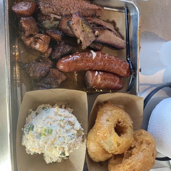 Heim Barbecue - jalapeño cheese sausage, sliced brisket, onion rings, bacon burnt ends, twice baked potato salad - Barbeque Near Me - Dallas, Texas