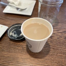a cup of coffee on a table a cup of coffee on a table