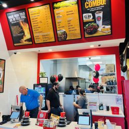 a man standing at a counter a man standing at a counter