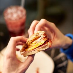 Bungalow Coffee - Our English Muffin Breakfast Sandwich comes with shaved ham, two eggs, cheddar cheese, & raspberry jam on an english muffin.