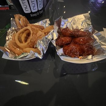 The Swamp Room - Onion Rings and Perfectly cooked wings tossed in Kickin' Bourbon sauce. - New American Near Me - Metairie, Louisiana The Swamp Room - Onion Rings and Perfectly cooked wings tossed in Kickin' Bourbon sauce. - New American Near Me - Metairie, Louisiana