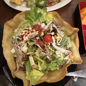 Uncle Julio's - Taco Salad full of mainly lettuce and few pieces of corn and cheese - Mexican Near Me - Orlando, Florida Uncle Julio's - Taco Salad full of mainly lettuce and few pieces of corn and cheese - Mexican Near Me - Orlando, Florida