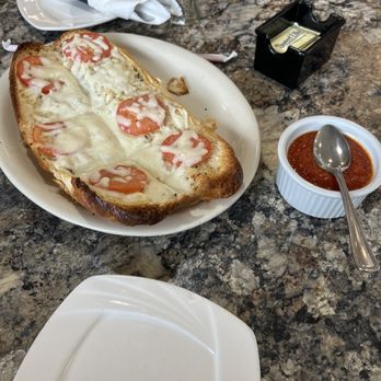 Napoli’s - Focaccia as an appetizer. Flaky bottom and delicious melted cheese complimenting a thin slice of tomato. - Italian Near Me - Richland, Washington