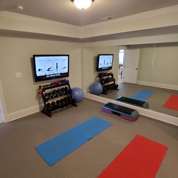 Evergreen Contracting Services - a home gym with a flat screen tv - General Contractors Near Me - Fairfax, Virginia