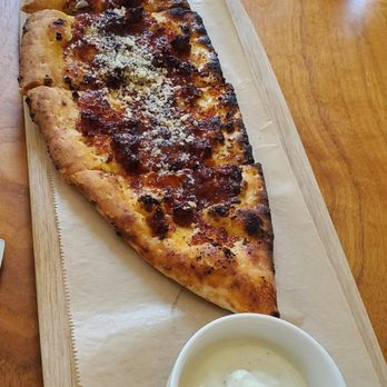 Stella 34 Trattoria - Piadina appetizer (Tuscan flat bread, sundried tomato capuliata, calabrian chili, honey, whipped ricotta). - Italian Near Me - New York, New York Stella 34 Trattoria - Piadina appetizer (Tuscan flat bread, sundried tomato capuliata, calabrian chili, honey, whipped ricotta). - Italian Near Me - New York, New York