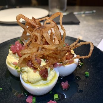 Curfew - Deviled eggs with pickled onions, candied Tasso, and bacon - New American Near Me - Memphis, Tennessee