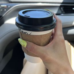 a woman holding a cup of coffee