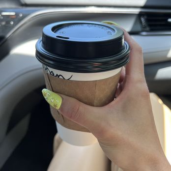 Patticakes In The Village - a woman holding a cup of coffee - Coffee & Tea Near Me - Gainesville, Florida