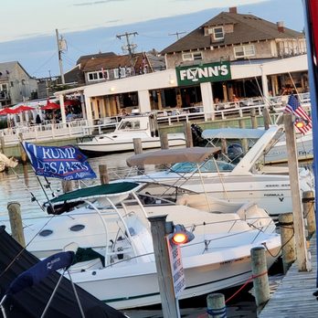Flynn's - a woman looking out of a boat window - Bars Near Me - Ocean Bay Park, New York