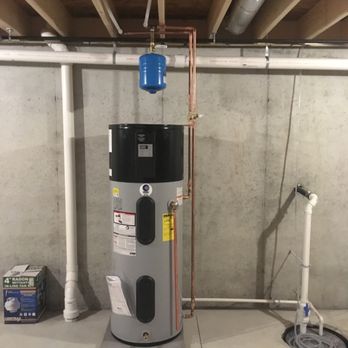 Wolfe Plumbing & Heating - a water heater in a basement - Plumbing Near Me Wolfe Plumbing & Heating - a water heater in a basement - Plumbing Near Me