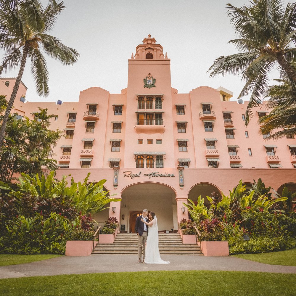 Bride and groom in front of the wedding venue. Bride and groom in front of the wedding venue.