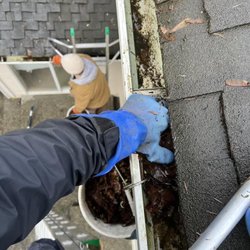 Husser Window and Gutter Cleaning - Husser crew cleaning gutters on a two story home in Seattle