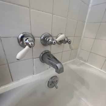 Eager Cleaners - Dirty spots in the tule and around the faucet. You can also see the water ring in the tub. - Home Cleaning Near Me