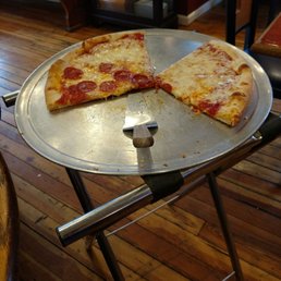a half eaten pizza on a pizza pan a half eaten pizza on a pizza pan
