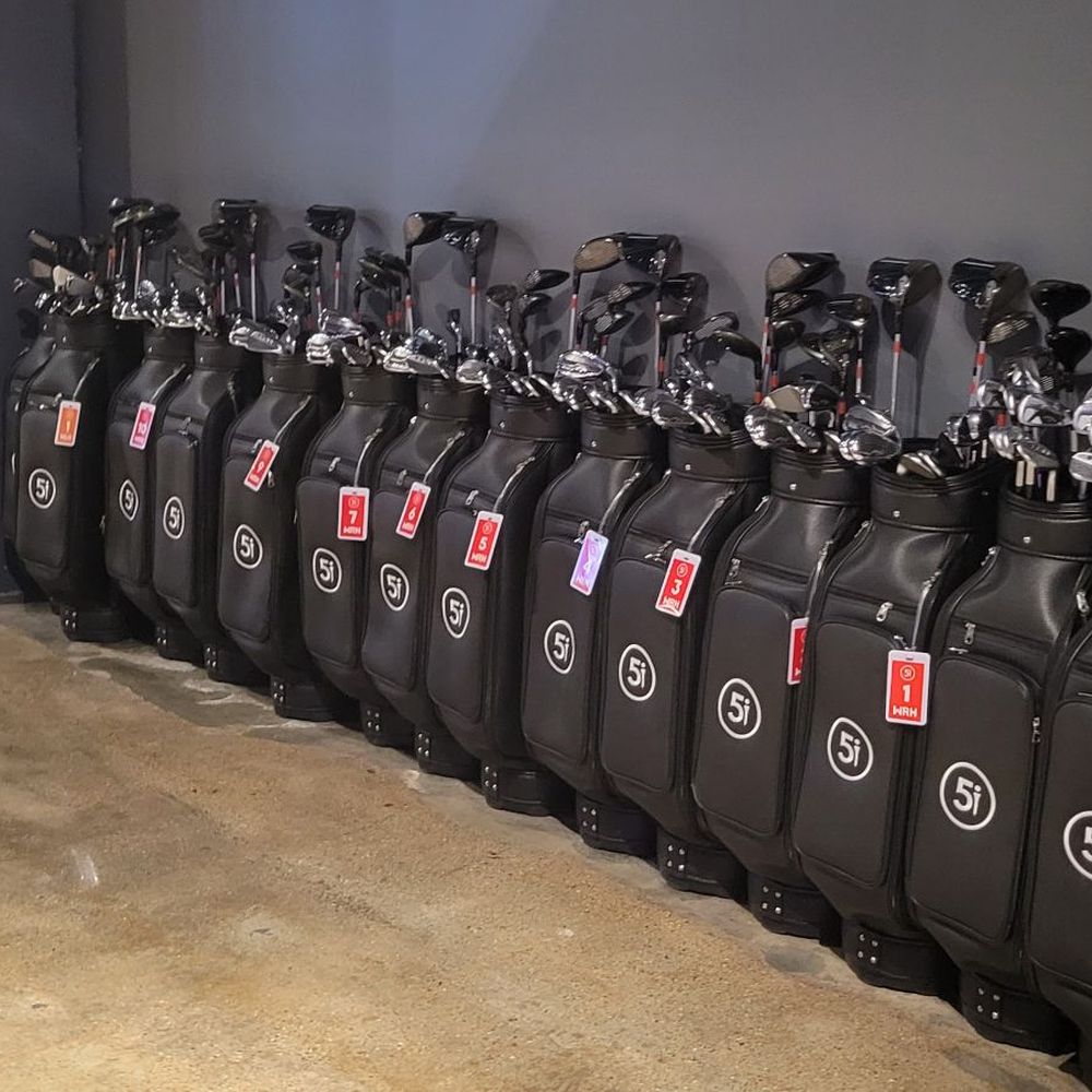 Five Iron Golf - a row of golf clubs - Sports Bars Near Me - Detroit, Michigan
