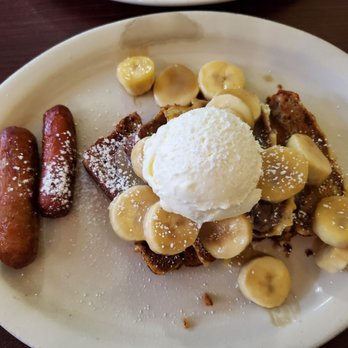 Patty's Eggnest - Banana Bread Foster: banana bread topped with sliced bananas, sautéed in butter, brown sugar, and cinnamon, topped with Devonshire cream. - Breakfast & Brunch Near Me - Tukwila, Washington Patty's Eggnest - Banana Bread Foster: banana bread topped with sliced bananas, sautéed in butter, brown sugar, and cinnamon, topped with Devonshire cream. - Breakfast & Brunch Near Me - Tukwila, Washington