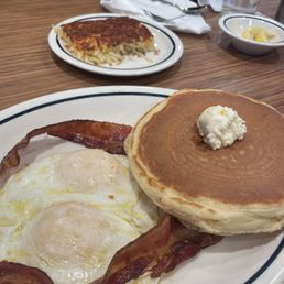 My $7 breakfast special. The pancakes were cold, the eggs over easy were not fully cooked, and the bacon had no flavor.