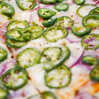 Pizza Station - a closeup of a pizza with jalapenos and onions - Pizza Near Me - Chappaqua, New York Pizza Station - a closeup of a pizza with jalapenos and onions - Pizza Near Me - Chappaqua, New York