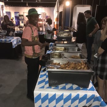 Biergarten - a man serving food to a woman - German Near Me - Huntsville, Alabama