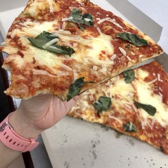 Artichoke Basille's Pizza - General size comparison of pizza slice to hand - Pizza Near Me - Berkeley, California Artichoke Basille's Pizza - General size comparison of pizza slice to hand - Pizza Near Me - Berkeley, California
