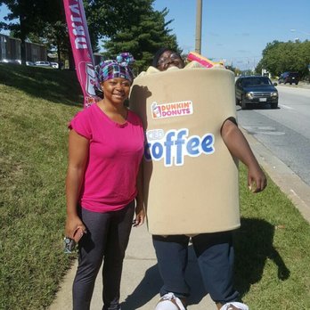Dunkin' - a woman standing next to a man in a dunkin donut costume - Coffee & Tea Near Me - Baltimore, Maryland Dunkin' - a woman standing next to a man in a dunkin donut costume - Coffee & Tea Near Me - Baltimore, Maryland