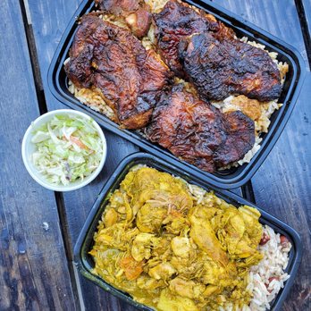 Roywoods - two trays of food on a wooden table - Caribbean Near Me - Toronto, Ontario