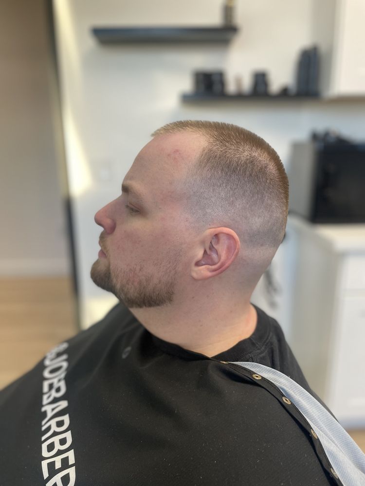 Against The Grain Barbershop Logo