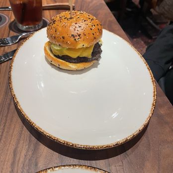 Haywire - Burger with the missing side of broccolini we had to wait for after waiting 30 minutes more for the food. - New American Near Me - San Antonio, Texas