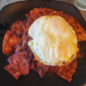 Estancia - Very sad chilaquiles. those red clumps is called the sauce and the road kill egg is over easy - Mexican Near Me - Chino, California Estancia - Very sad chilaquiles. those red clumps is called the sauce and the road kill egg is over easy - Mexican Near Me - Chino, California
