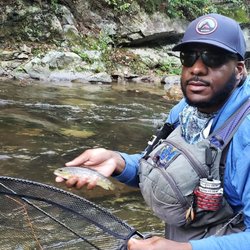 Turning Stone's Fly Fishing - Richard with a small wild Browntrout.