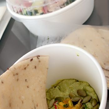 Flower Child - Avocado hummus with pita bread and a turkey and avocado Cobb salad in the back - Salad Near Me - Atlanta, Georgia Flower Child - Avocado hummus with pita bread and a turkey and avocado Cobb salad in the back - Salad Near Me - Atlanta, Georgia