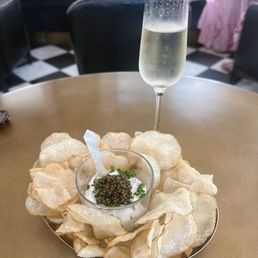 Caviar with creme fraiche and very thin fried potato slices and a glass of Prosecco. Divine! Caviar with creme fraiche and very thin fried potato slices and a glass of Prosecco. Divine!