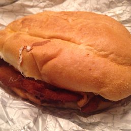 Cemita Especial: Milanesa de pollo, ham, bacon, a fried egg, sliced avocado, queso blanco, and a pickled chile pepper
