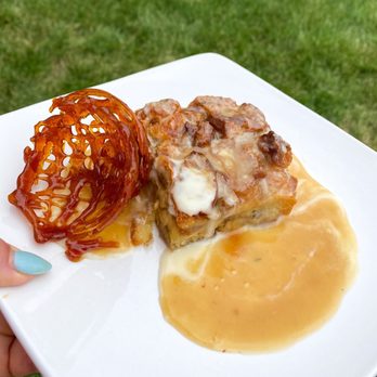 The Passenger - Bread pudding with vanilla bean sauce and caramel-whiskey drizzle. - New American Near Me - Longmont, Colorado