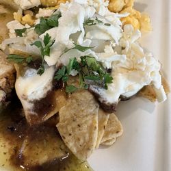 City Express - Free Breakfast: Chilaquiles drenched in green sauce, beans, cheese and crema.  Side of Eggs and ham