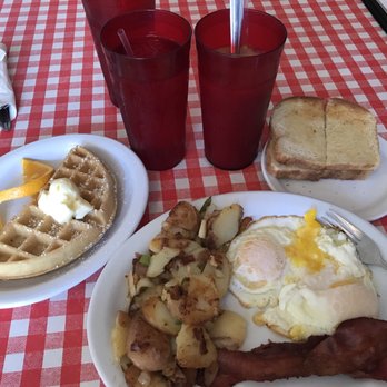The Roost Cafe - Two eggs over medium, two pieces of bacon, country potatoes, sourdough toast, half a waffle, and iced coffee - Breakfast & Brunch Near Me - Chico, California The Roost Cafe - Two eggs over medium, two pieces of bacon, country potatoes, sourdough toast, half a waffle, and iced coffee - Breakfast & Brunch Near Me - Chico, California