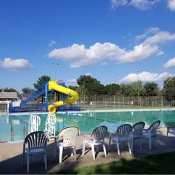 Bongiorno Conference Center - Outdoor swimming pool with a yellow spiral slide at Bongiorno Conference Center, offering recreational fun for youth retreats...