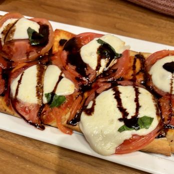 The Chocolatier - Flatbread with tomato, mozzarella, basil and chocolate balsamic drizzle. - New American Near Me - Hershey, Pennsylvania