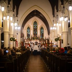 All Saints Episcopal Church - At the 2018 Houses of Worship Tour, the adult choir sings carols for onlookers to enjoy.