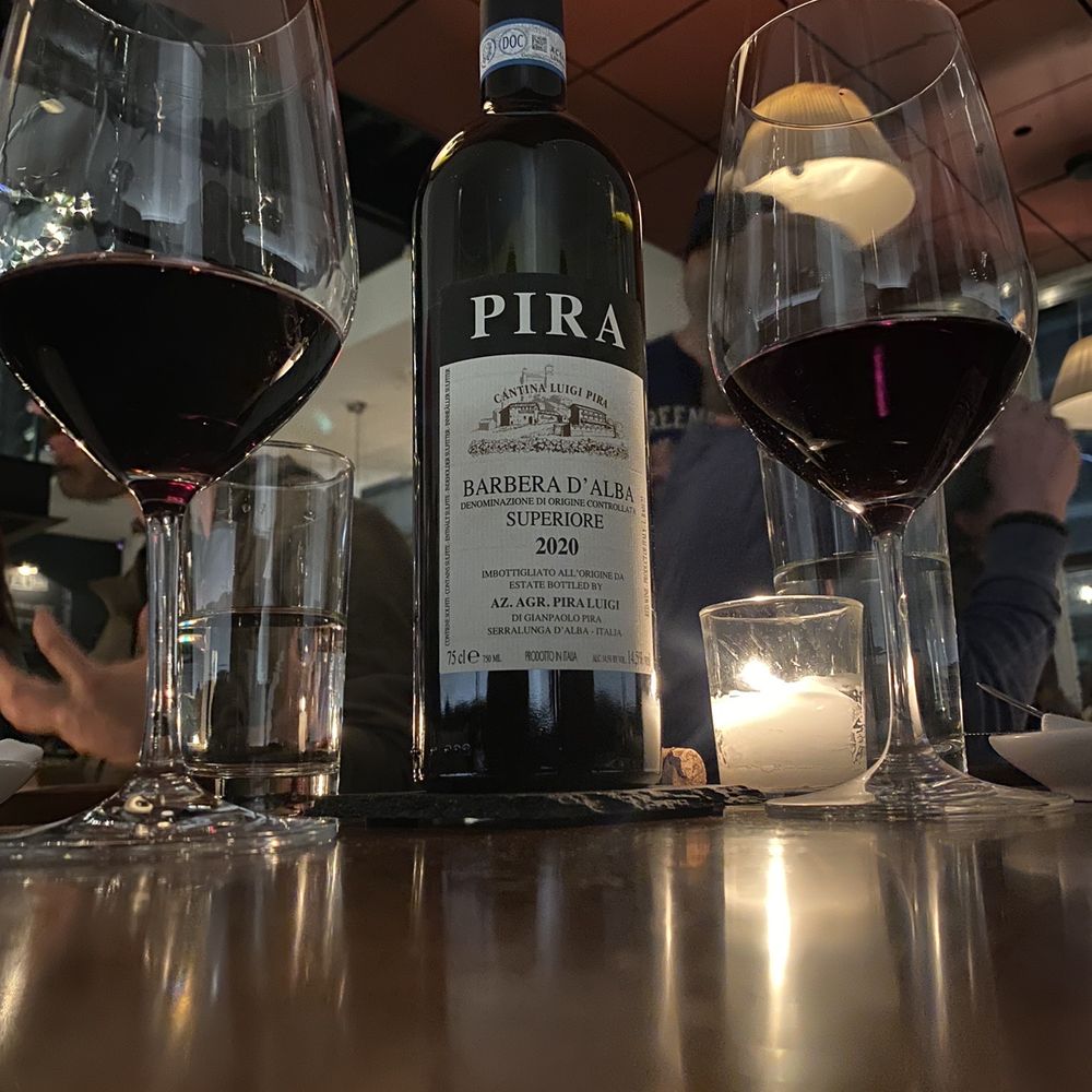 two glasses of wine and a bottle of wine