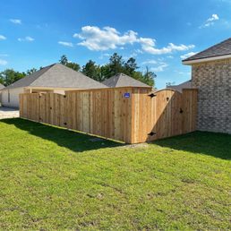 a fenced yard with a wooden privacy panel