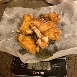 a digital scale with a pile of wings on it