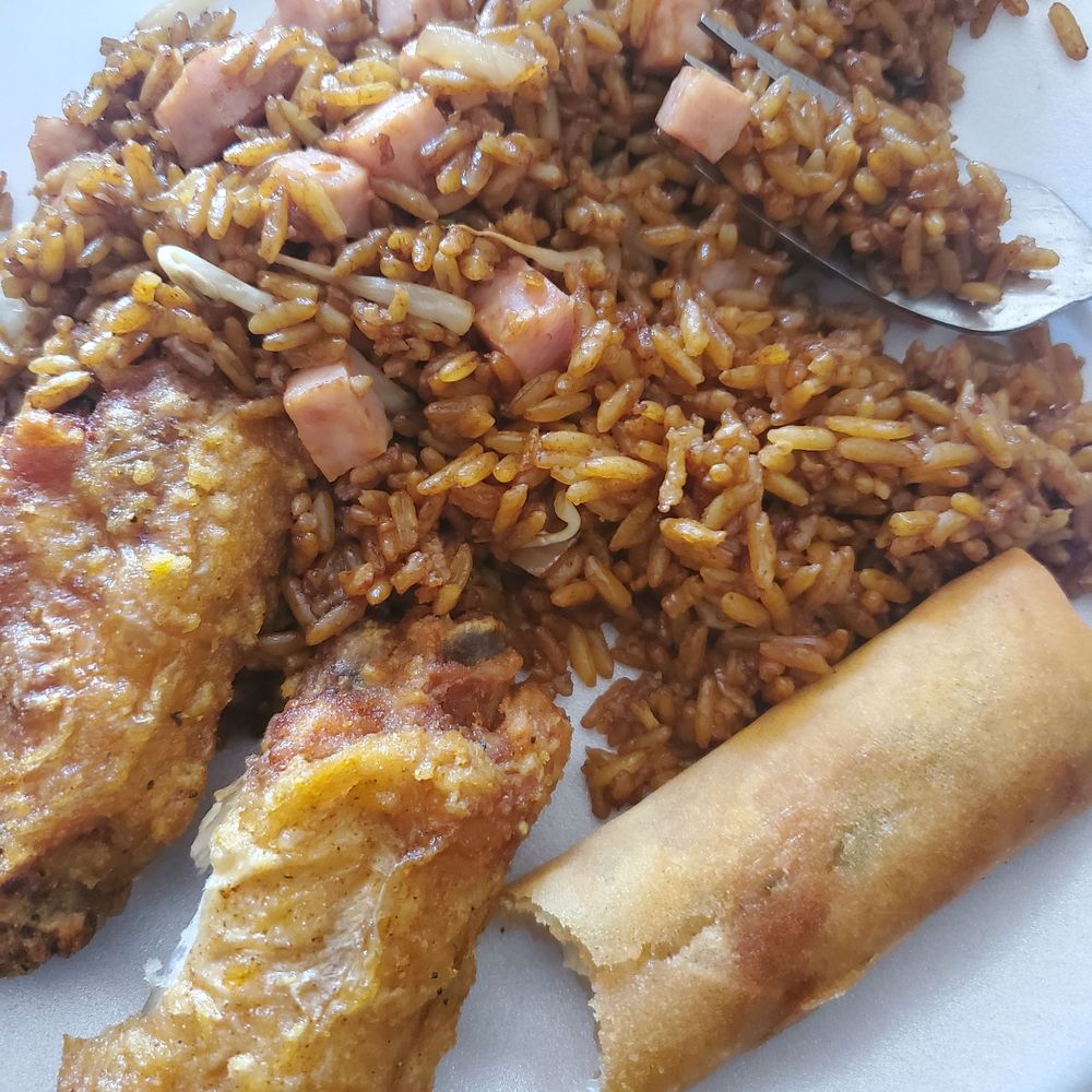 Lemon pepper wings, ham fried rice, and spring roll with a bite out Lemon pepper wings, ham fried rice, and spring roll with a bite out