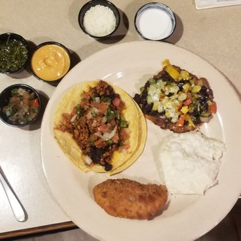 Roots Latin Grill - Tostones, empanada, tofu taco and sinfully good cheesy rice - Latin American Near Me - Springfield, Illinois Roots Latin Grill - Tostones, empanada, tofu taco and sinfully good cheesy rice - Latin American Near Me - Springfield, Illinois