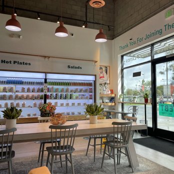 Everytable - the inside of a restaurant with tables and chairs - Salad Near Me - Compton, California