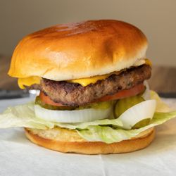 Sumo Hibachi & Wings - Seasoned Half a pound beef patty with melted American cheese, lettuce, onion, tomato, pickles, ketchup, mayo, and mustard on brioche buns.