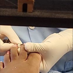 Mimi Nails and Spa - Her using the knife thing to slice my polish after she had already cut me and I was bleeding already.