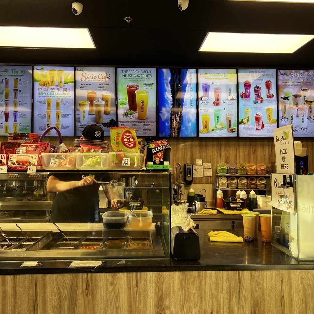 Presotea - a restaurant counter with menus in the background - Bubble Tea Near Me - Brossard, Quebec Presotea - a restaurant counter with menus in the background - Bubble Tea Near Me - Brossard, Quebec