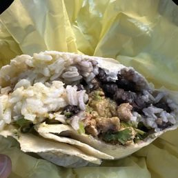 White Rice, chicken, black beans, guacamole, cilantro, Verde sauce.